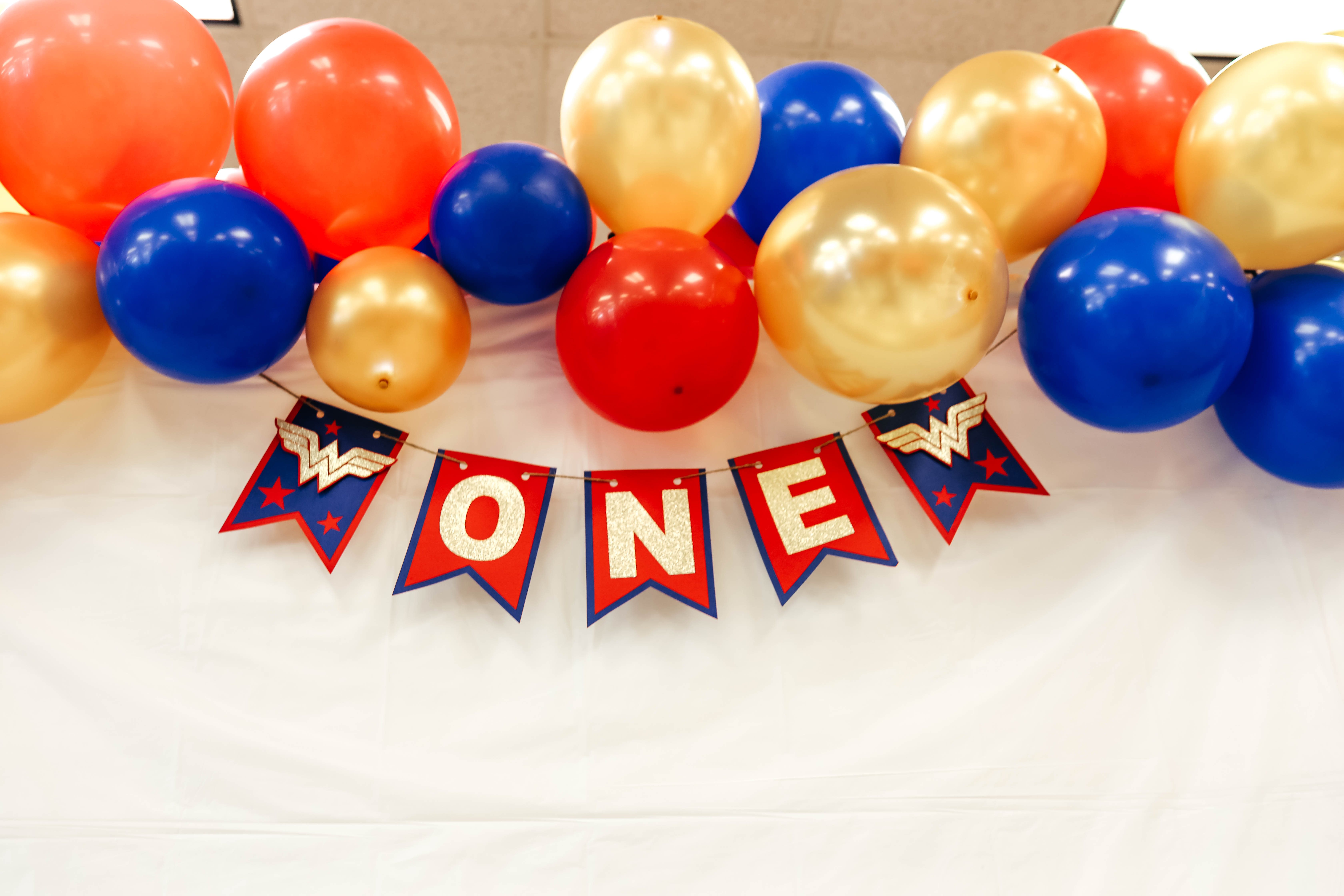 ONEder Woman First Birthday Party Decorations and Wonder Woman balloons - on Coming Up Roses