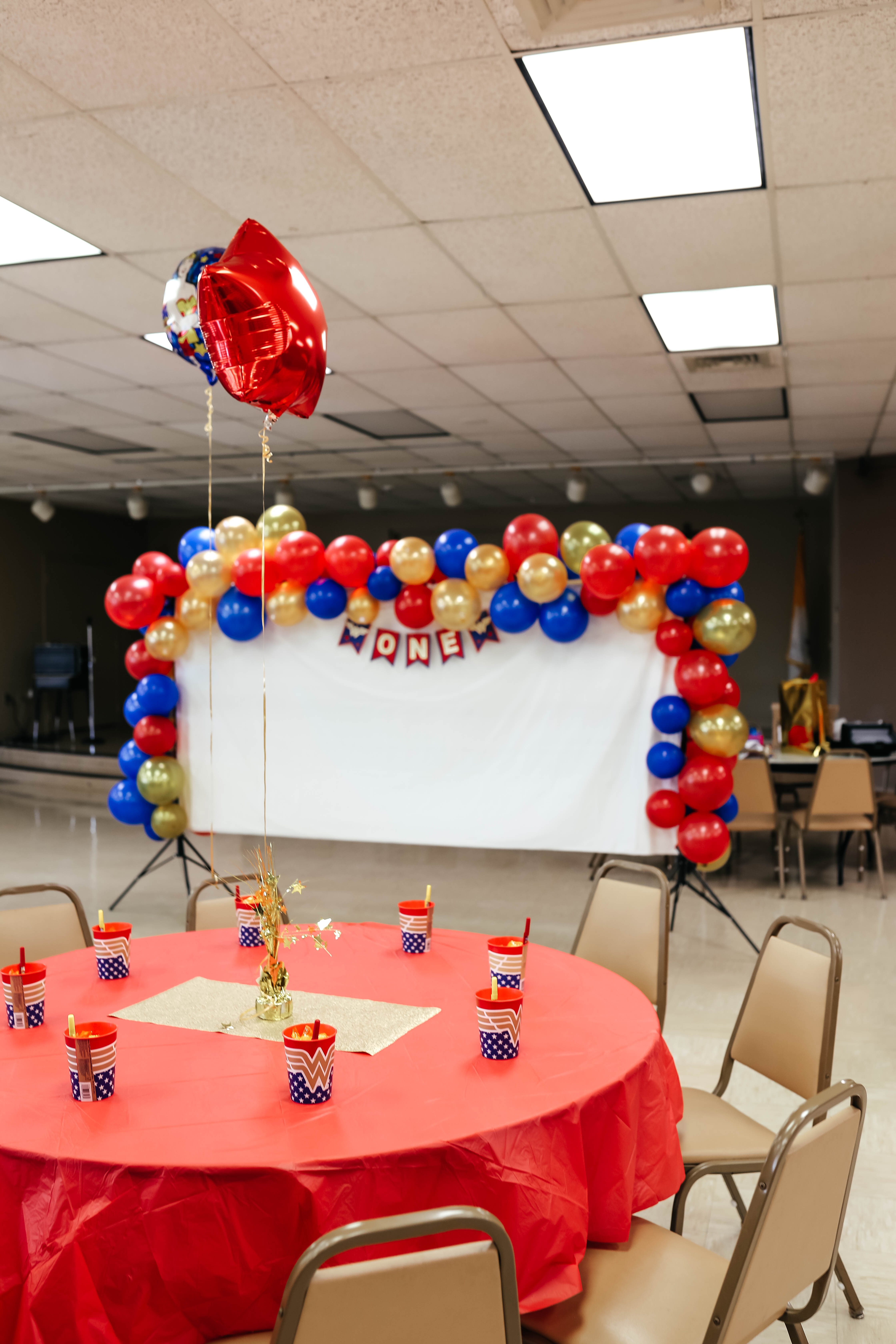 ONEder Woman First Birthday Party Decorations and Wonder Woman balloons - on Coming Up Roses